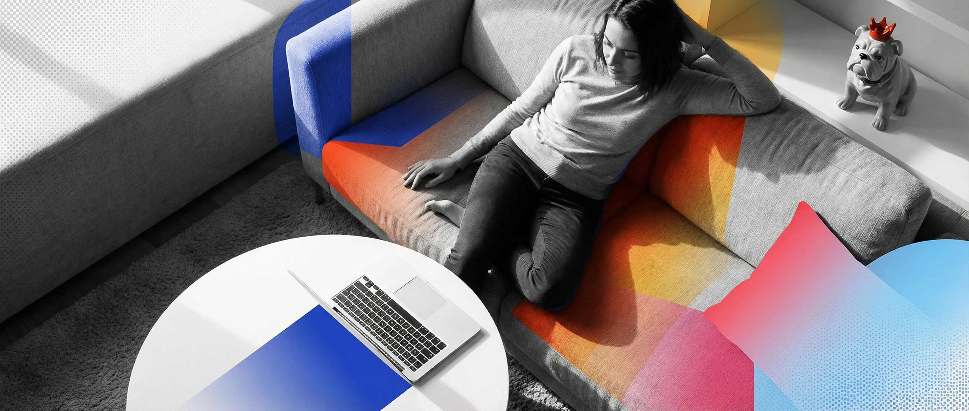 Woman relaxing on colorful sofa with laptop